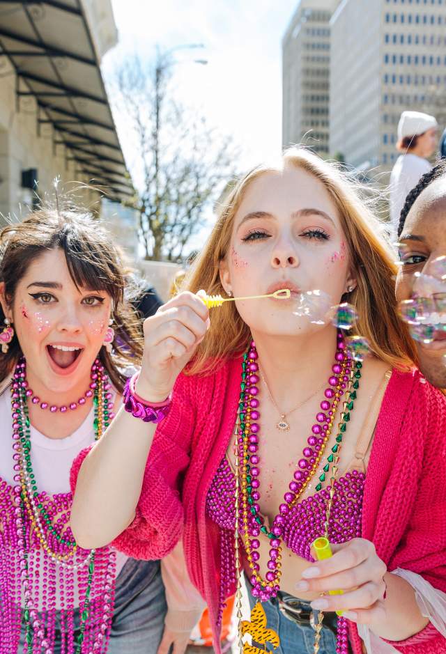 four girls at Spanish Town Mardi Gras Parade