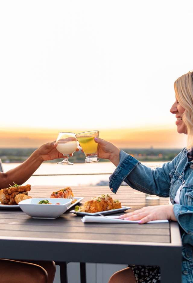 two women dining at Tsunami Sushi overlooking the Mississippi River